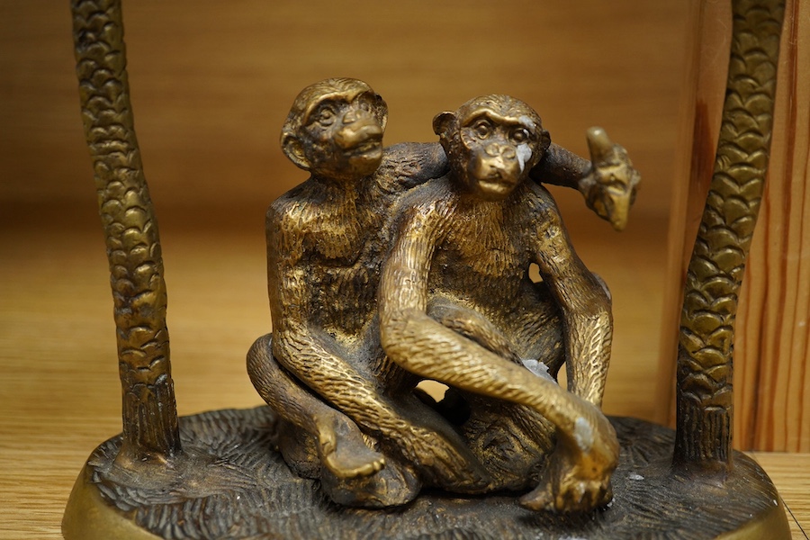 A brass two branch candleholder in the form of palm trees and monkeys, 22cm high. Condition - fair